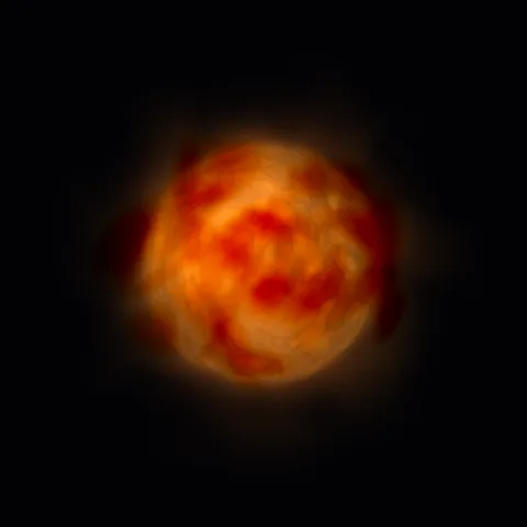 An orange-red star half hidden by its own cloud of dust.